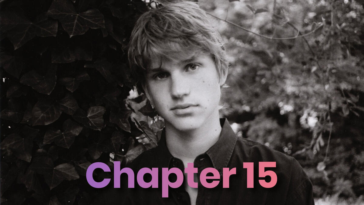 A black-and-white senior portrait of a young man standing in front of trees.